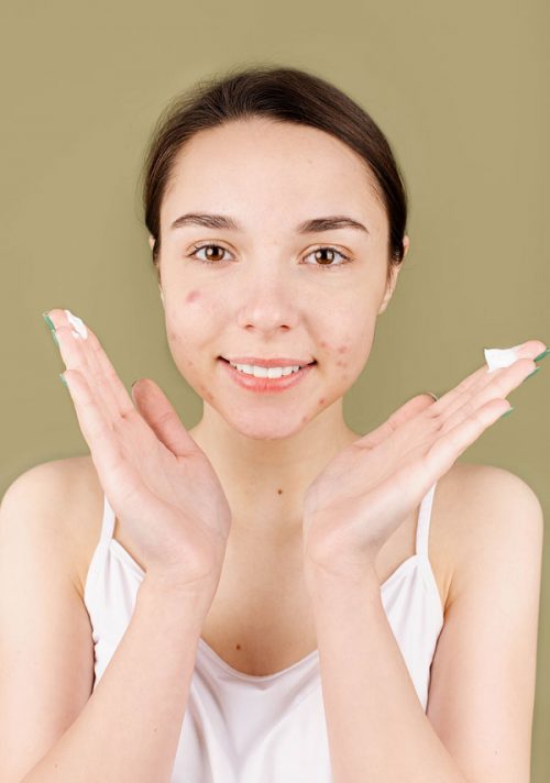 Woman with Cream on Fingers